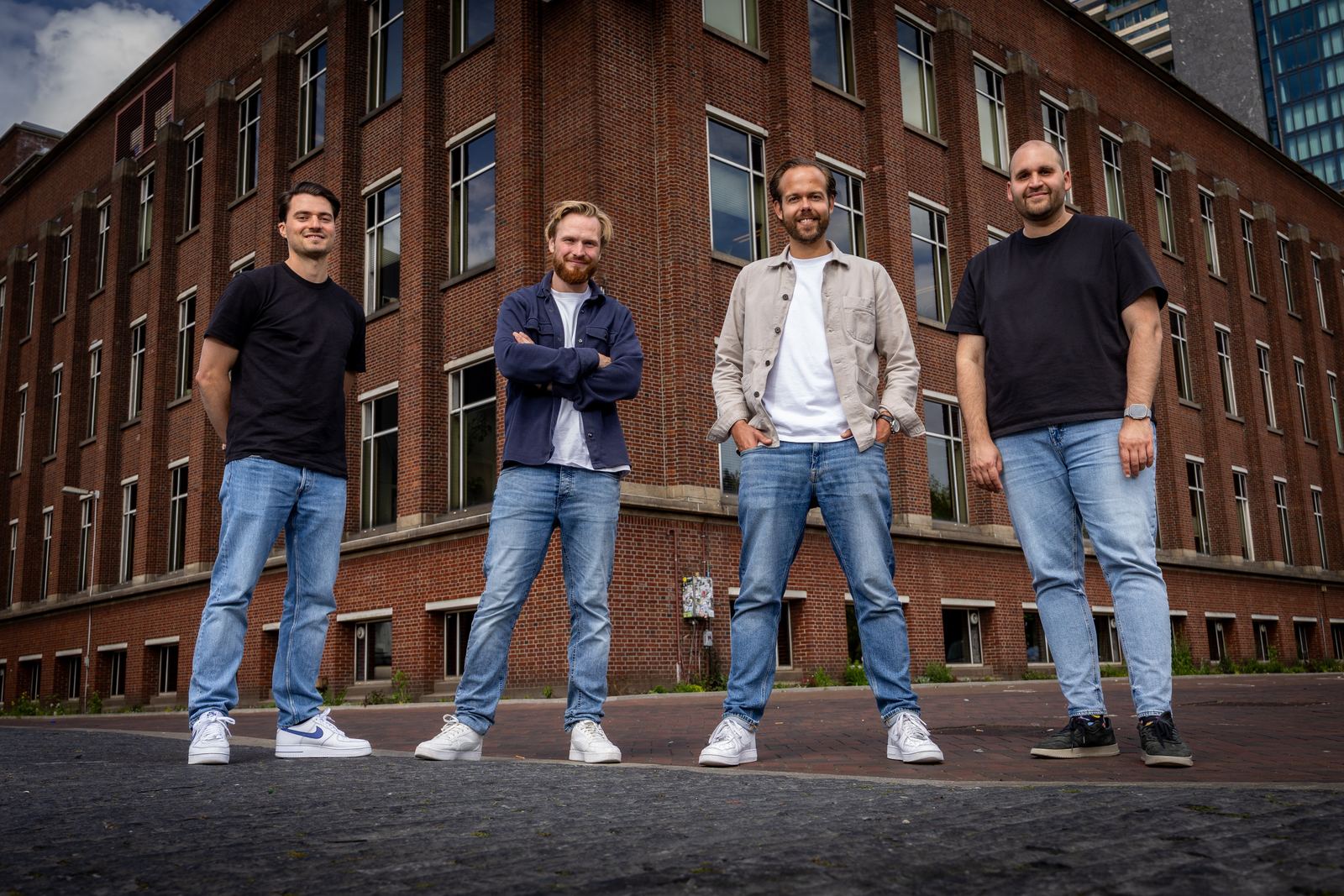 Lleverage founders Tom van Wees, Lennard Kooy, Tim Beyer and Badr Eddial, left to right, outside a brick office building