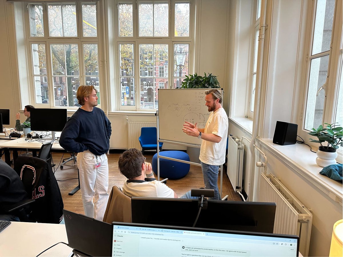Lleverage colleagues talking through a whiteboard sketch in the Amsterdam office