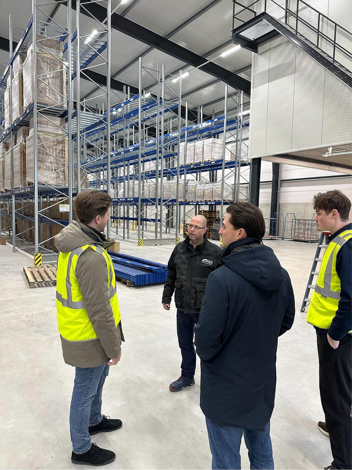 The Lleverage team in hi-vis vests on a customer's warehouse floor